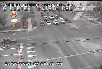 A cross street intersection with moderate traffic flow, including cars and a van, near a Burger King restaurant; no visible work zones or incidents.