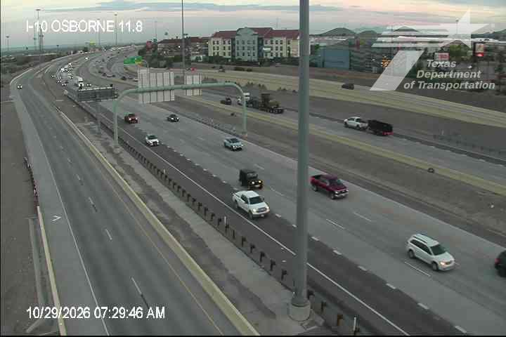 Multi-lane highway with moderate traffic flow, including passenger cars and trucks, under clear skies with no visible work zones or incidents.