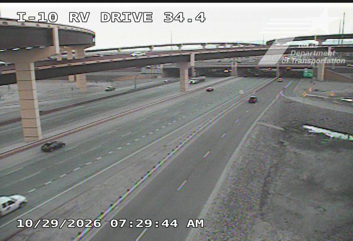 Multi-level highway with moderate traffic under overpasses, no visible incidents or road work.