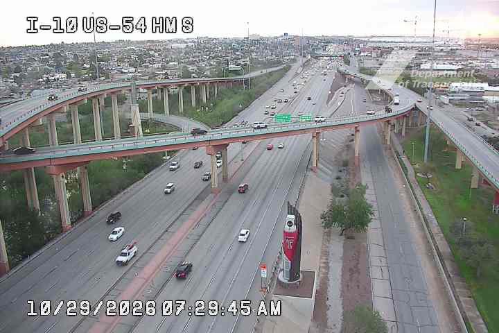 Multi-level highway with moderate traffic flowing in both directions under an overpass, with no visible incidents or road work.