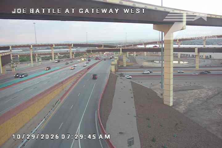 Multi-level highway interchange with moderate traffic flow under overpasses, clear visibility, no visible incidents or road work.