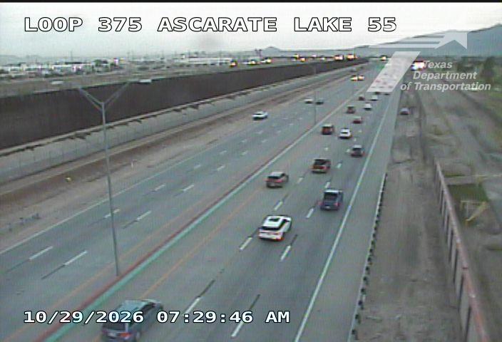 Light traffic flows smoothly on a multi-lane highway with no visible incidents or road work; vehicles are spaced evenly across lanes under overcast skies.