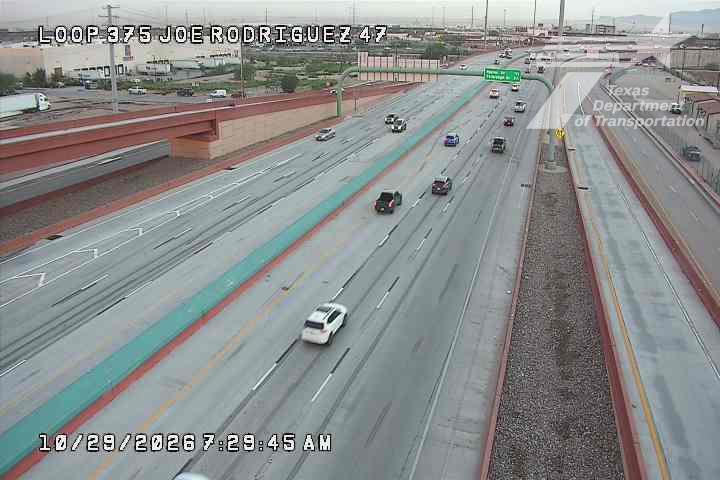 Multi-lane highway with moderate traffic flow, vehicles moving in both directions under clear skies.