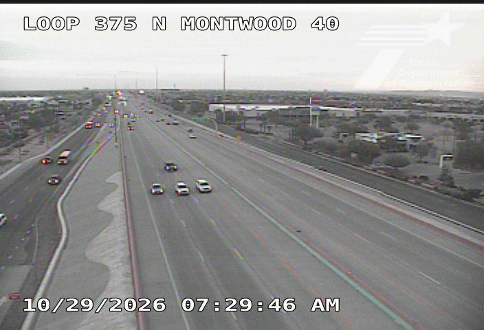 Light traffic flows smoothly across a multi-lane highway with no visible incidents or road work, under overcast skies.