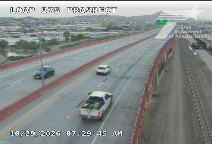 Light traffic on a multi-lane highway with a white pickup truck and two cars moving in the same direction; no visible work zones or incidents.
