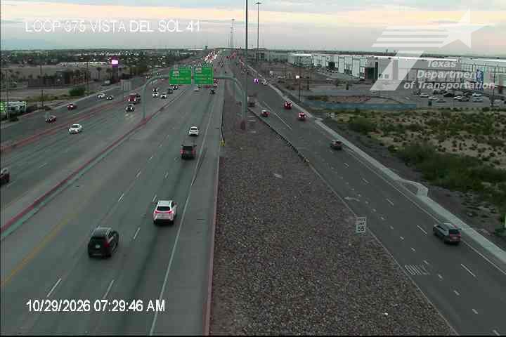 Light traffic flows along a multi-lane highway with vehicles moving in both directions; no visible incidents or road work.