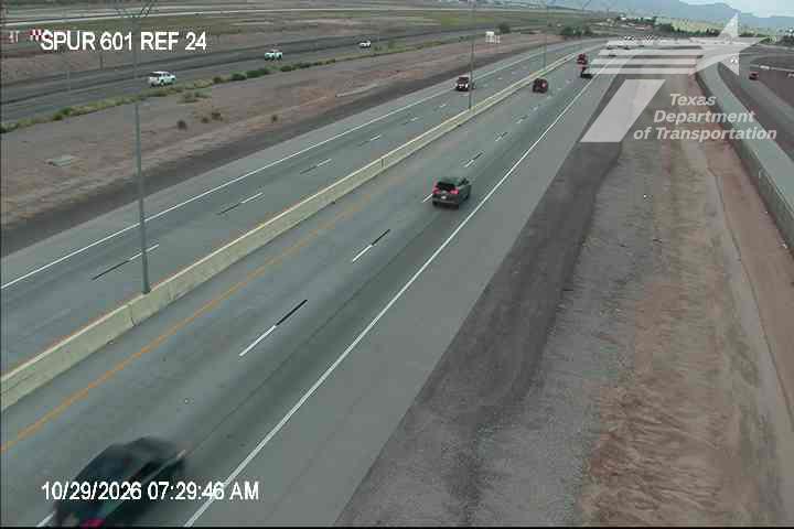 Multi-lane highway with moderate traffic flow, vehicles moving freely in both directions, no visible incidents or road work zones.