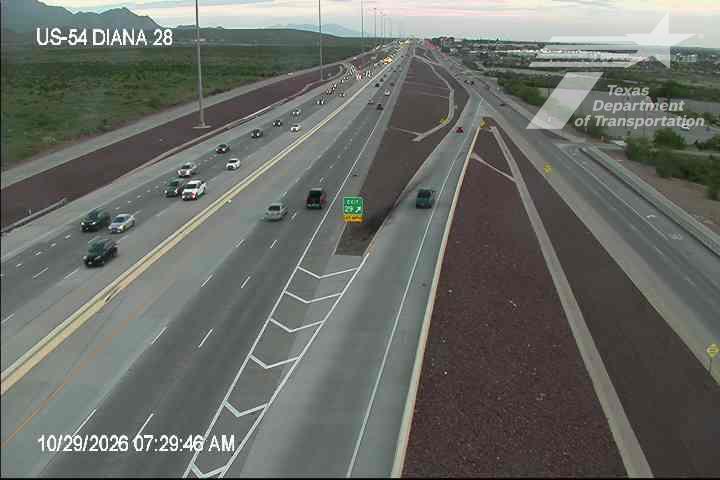 Multi-lane highway with moderate traffic flowing in both directions, no visible incidents or road work, clear weather with good visibility.