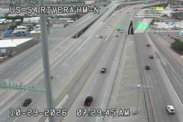 Multi-lane highway with moderate traffic flowing in both directions under clear weather conditions, featuring an overpass and no visible work zones or incidents.