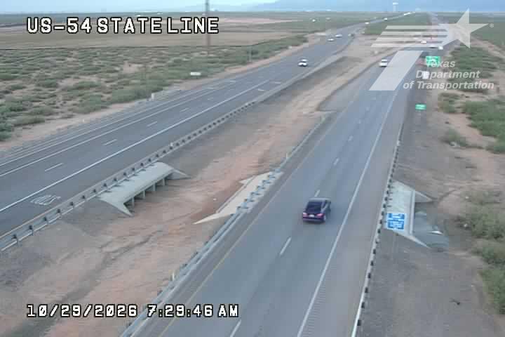 A multi-lane highway with light traffic flows in both directions, separated by a median barrier; no visible work zones or incidents.